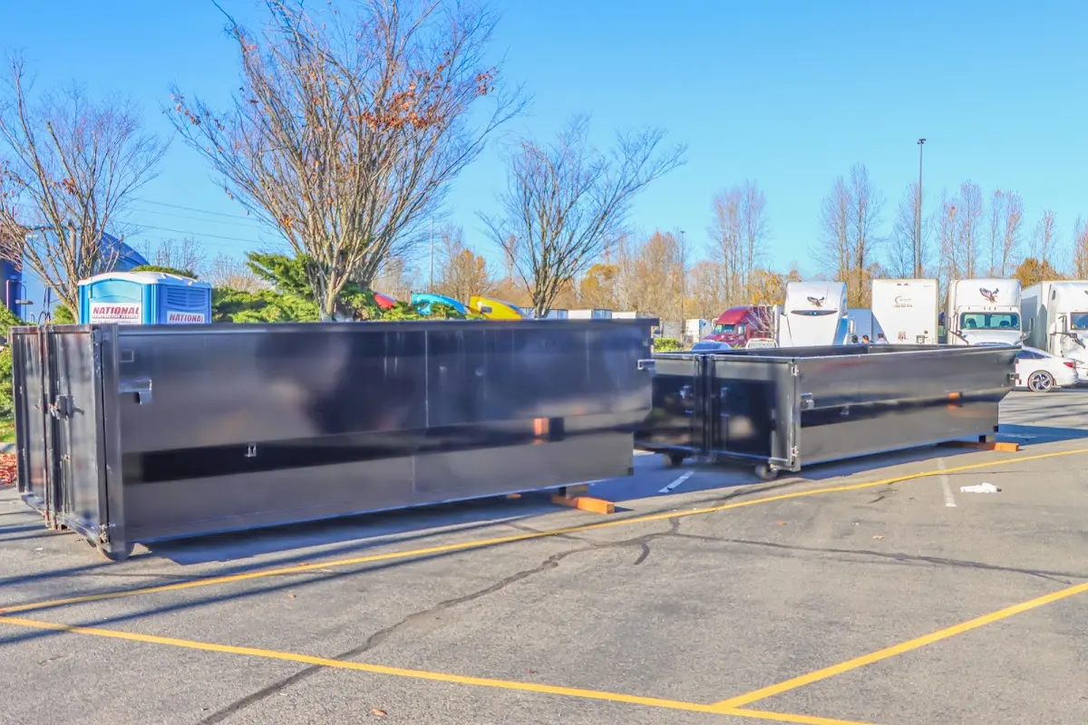 Professional dumpster rental service with roll-off container on residential driveway in Rotterdam